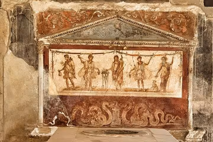 Ancient fresco depicting Roman figures on a wall in Herculaneum, showcasing historical artistry on guided tours.