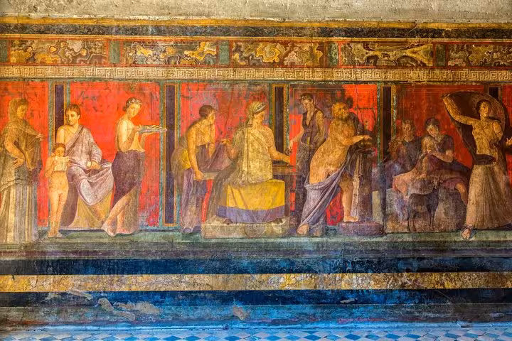 Vibrant frescoes depicting Roman life in Herculaneum, highlighting cultural exploration on the Naples shore tour.