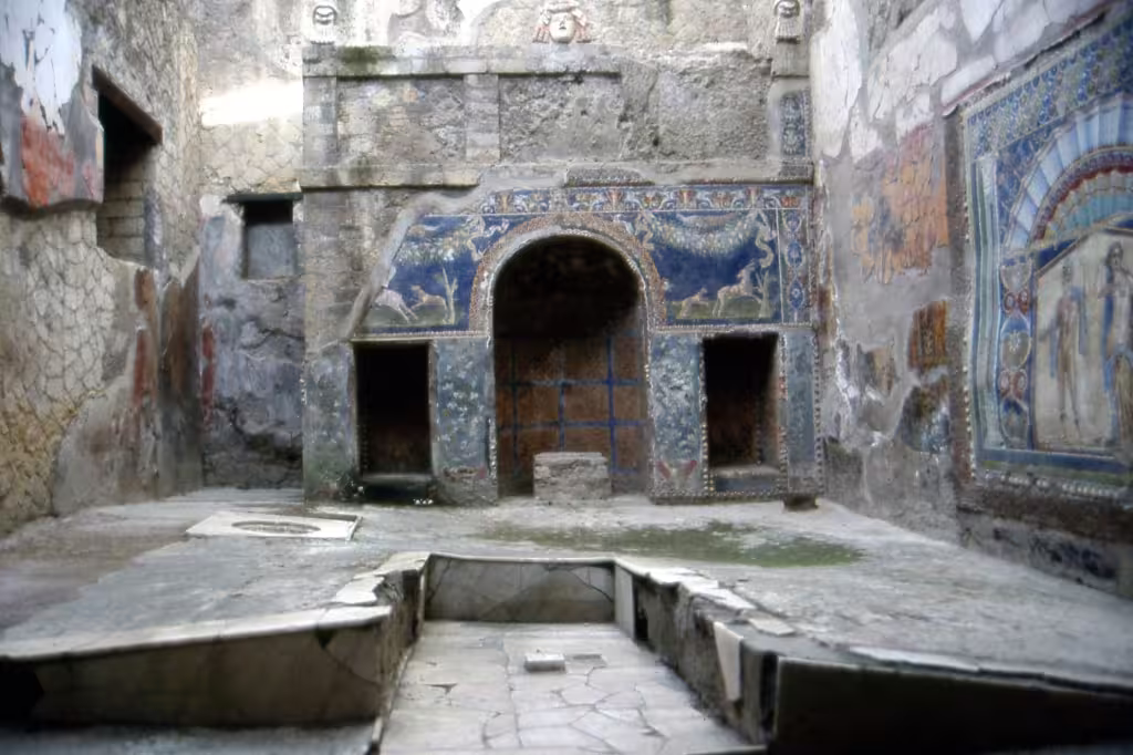 Intricate mosaics and frescoed walls inside a richly decorated Roman room at Herculaneum on a guided private half-day tour