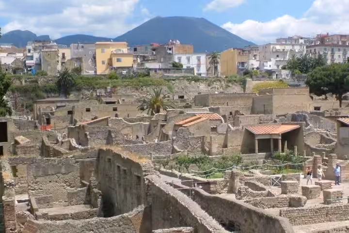 Panoramic view of Herculaneum ruins with Mount Vesuvius and Ercolano town in the background on a private half-day tour