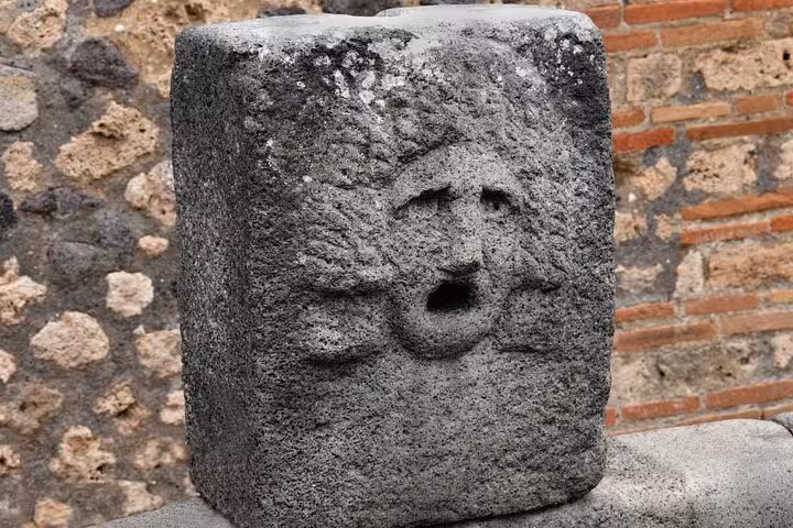 Ancient carved stone at Herculaneum archaeological site for skip-the-line tour with easy lunch included.