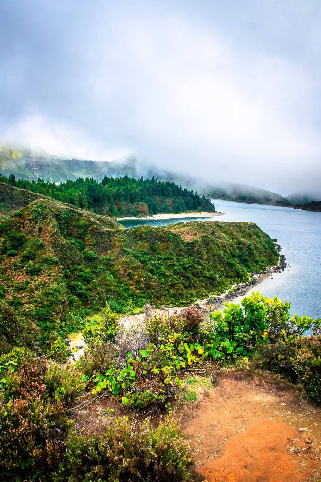 Misty viewpoint over Lagoa do Fogo crater lake in São Miguel Azores, panoramic highlight on hiking tour