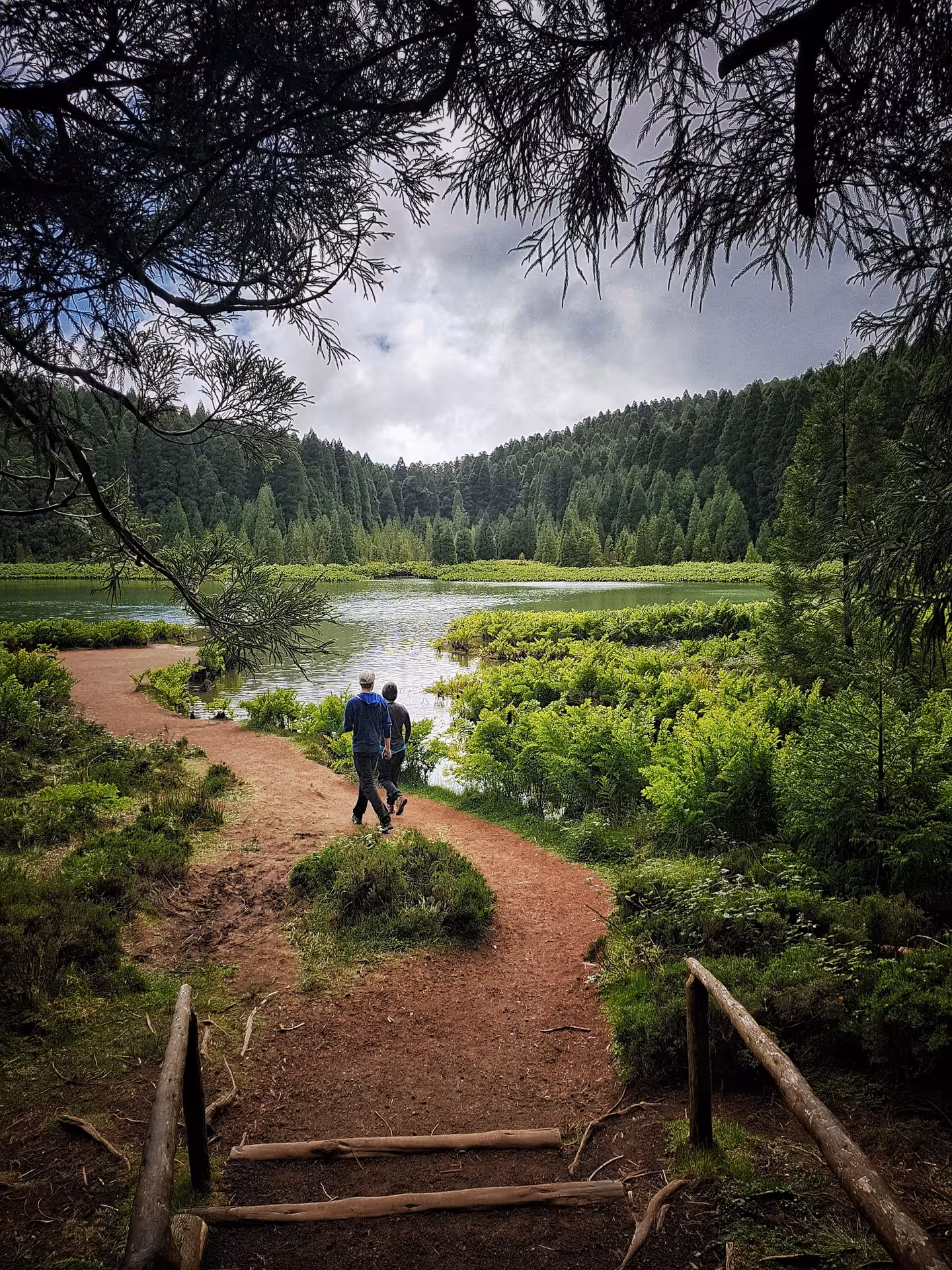 Hikers on lakeside path in Sete Cidades crater on HIKE Seven Cities - Ferraria trek, São Miguel Azores