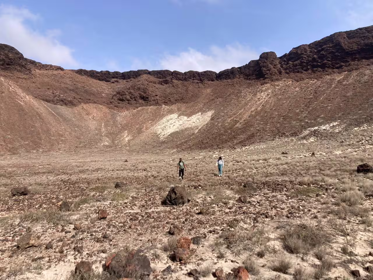 Hikers explore the rugged terrain inside Volcano Viana's crater, offering a unique adventure on São Vicente, Cape Verde.