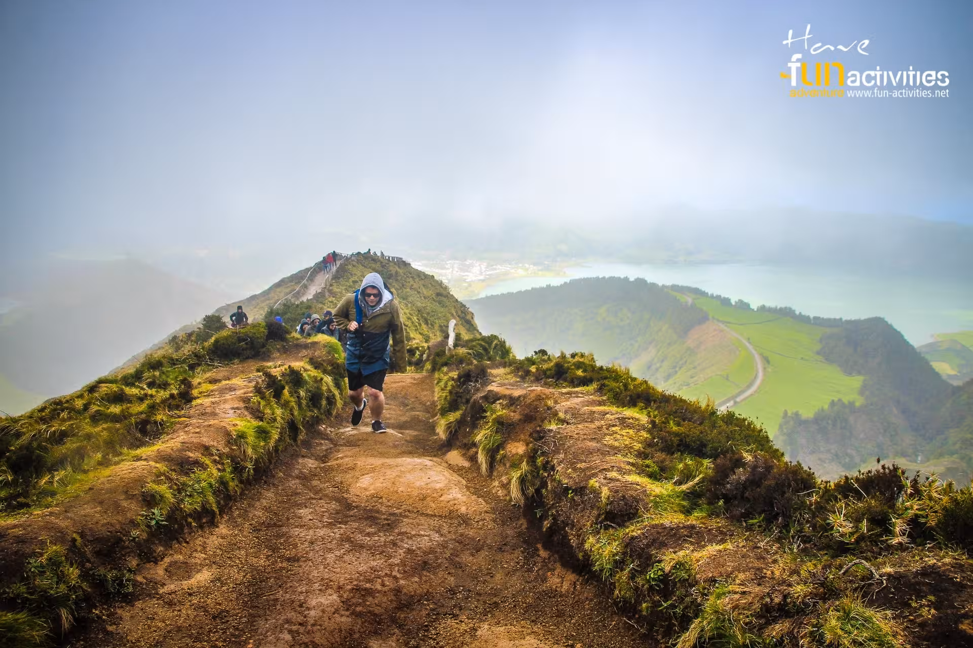 Hiker on the Sete Cidades ridge trail with lagoon views, part of the Seven Cities to Ferraria hike, Azores
