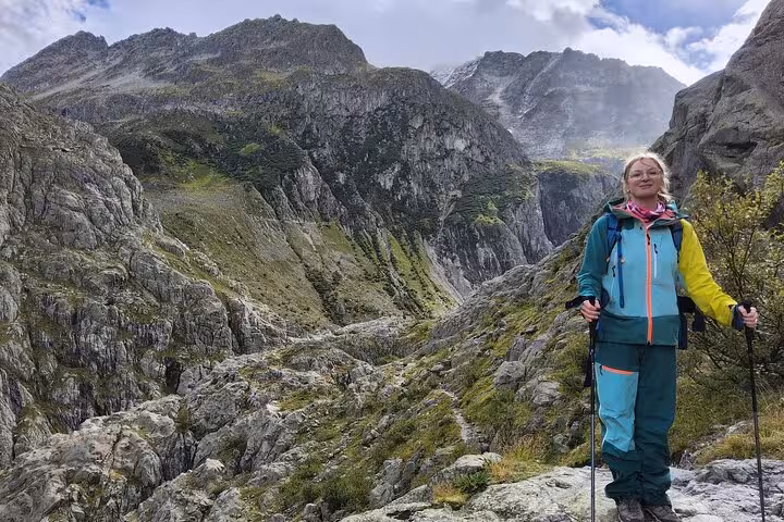 Hiker on alpine trail near Trift Suspension Bridge, Swiss Alps scenery on Zurich day trip adventure