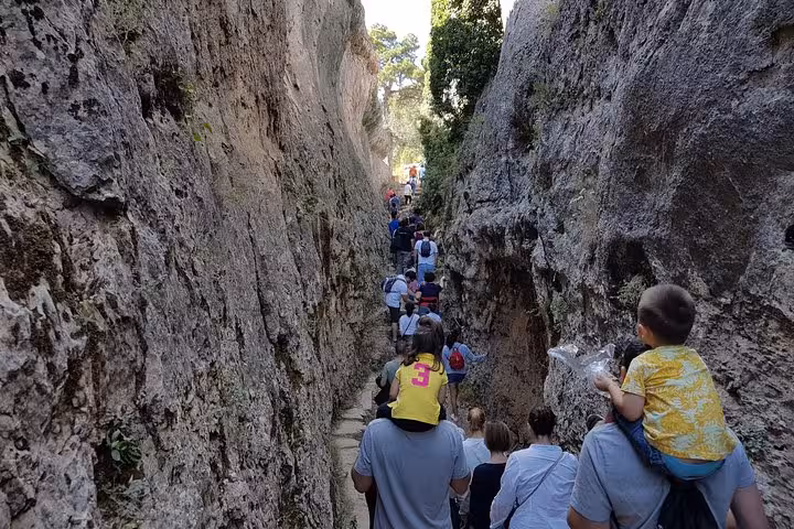 Hikers in a narrow rock corridor at Enchanted City near Cuenca on Ventano del Diablo day tour