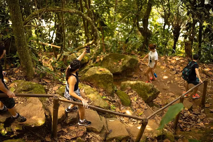 Hikers exploring a lush forest trail to Sono Beach on the Paraty Tours adventure experience.