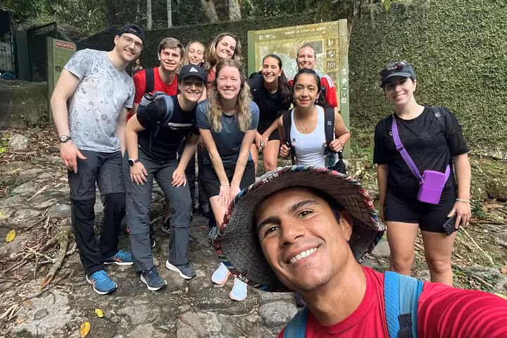 Happy hikers posing before starting the Garganta do Céu and Waterfall hike in Pedra da Gávea, Rio de Janeiro.