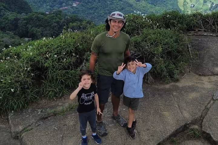 Smiling hikers enjoying panoramic views on the Trail to Beautiful Stone in DA Tijuca Forest.