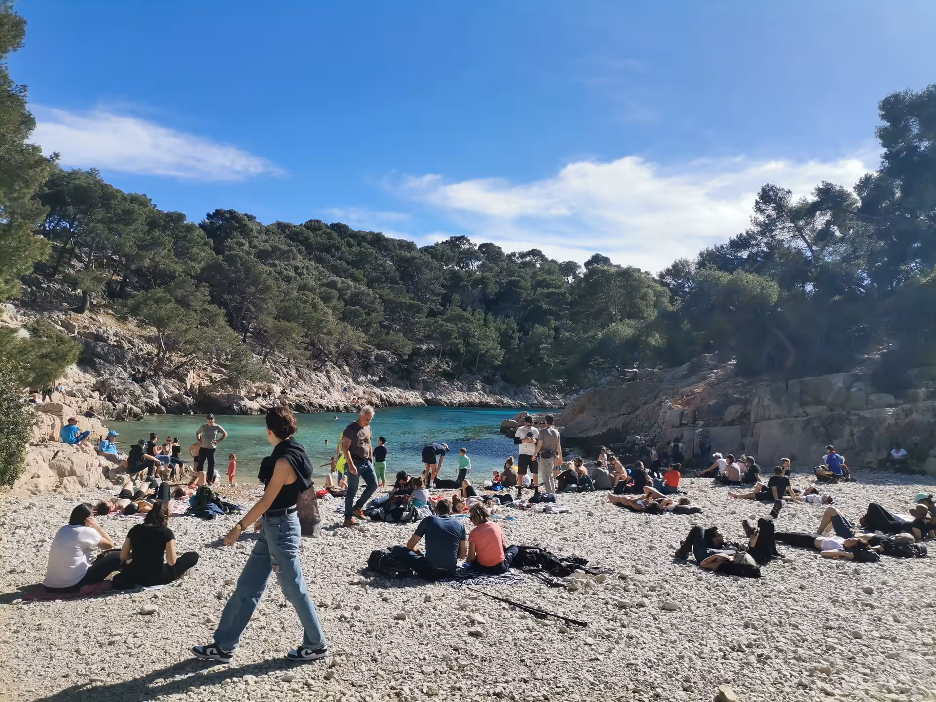 Hikers relaxing on the pebble beach at Port-Pin Calanque during En-Vau and Port-Miou guided hike, Cassis
