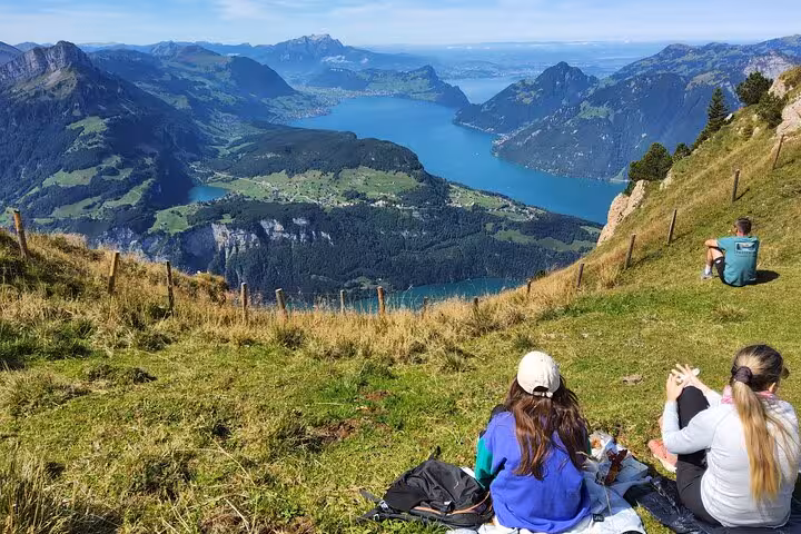Hikers picnic on Mount Rigi above Lake Lucerne, a highlight of the Zurich day trip with alpine views