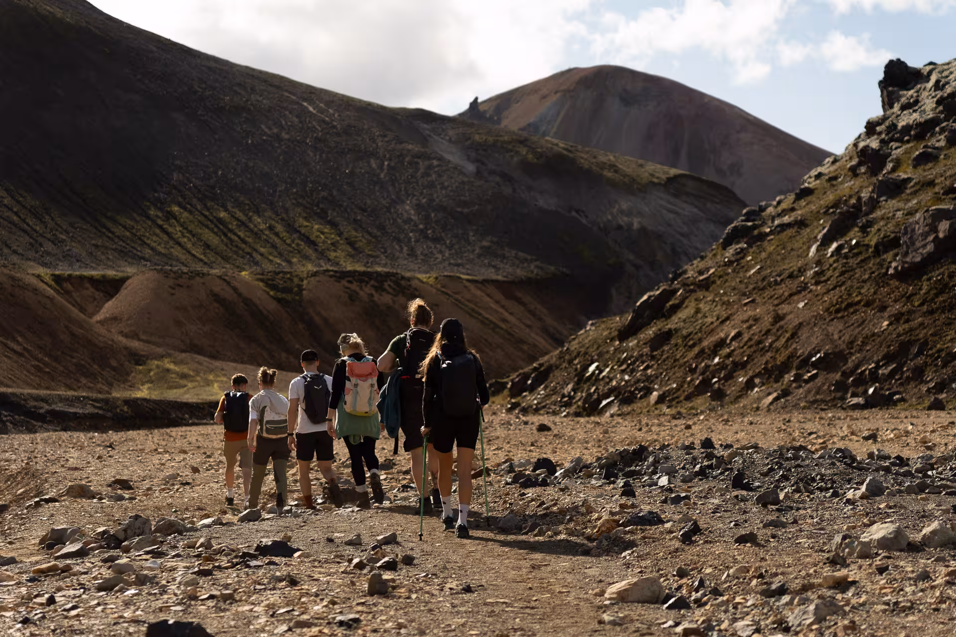 Hikers trekking a volcanic trail in Landmannalaugar, Iceland Highlands, on a guided hiking and 4x4 tour