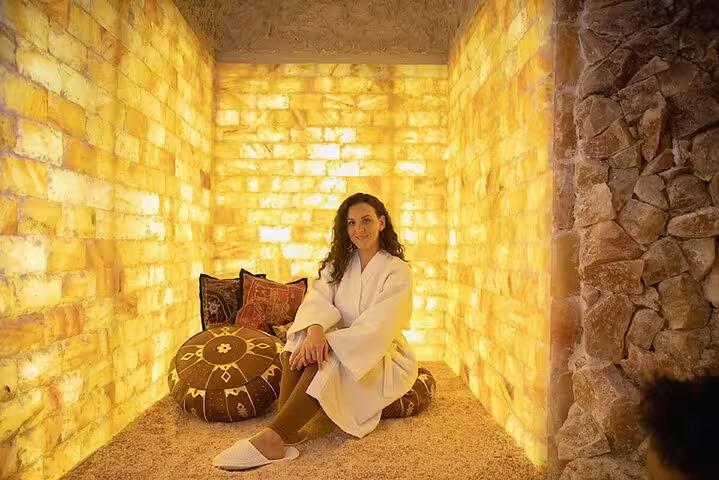 Guest relaxing in a glowing Himalayan salt room in Sharm El Sheikh, part of salt cave and local shopping tour