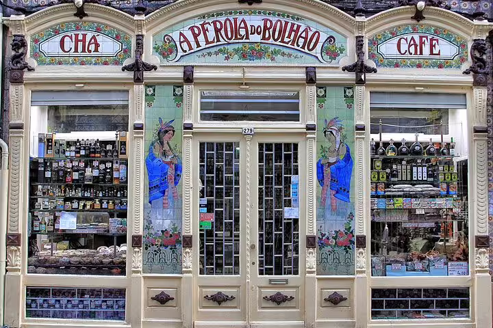 Charming historic café storefront in Bolhão, Portugal, showcasing vintage tiles and local delicacies on a private Tuk Tuk tour stop.
