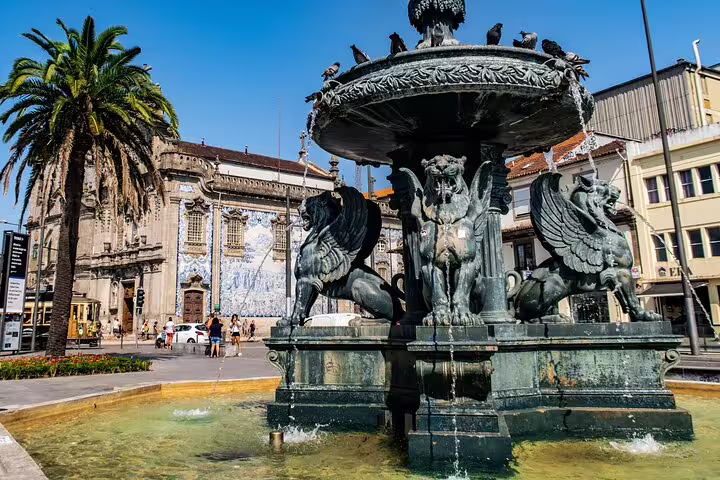 Historic center tuk tuk tour highlights ornate stone fountain and palm tree against vibrant urban backdrop.