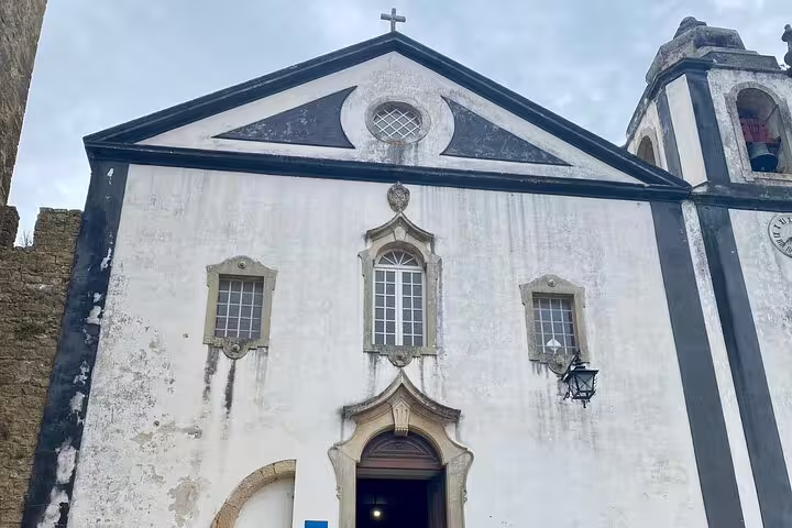Historic church facade in Óbidos, Portugal, showcasing classic architecture on the Lisbon to Óbidos tour.
