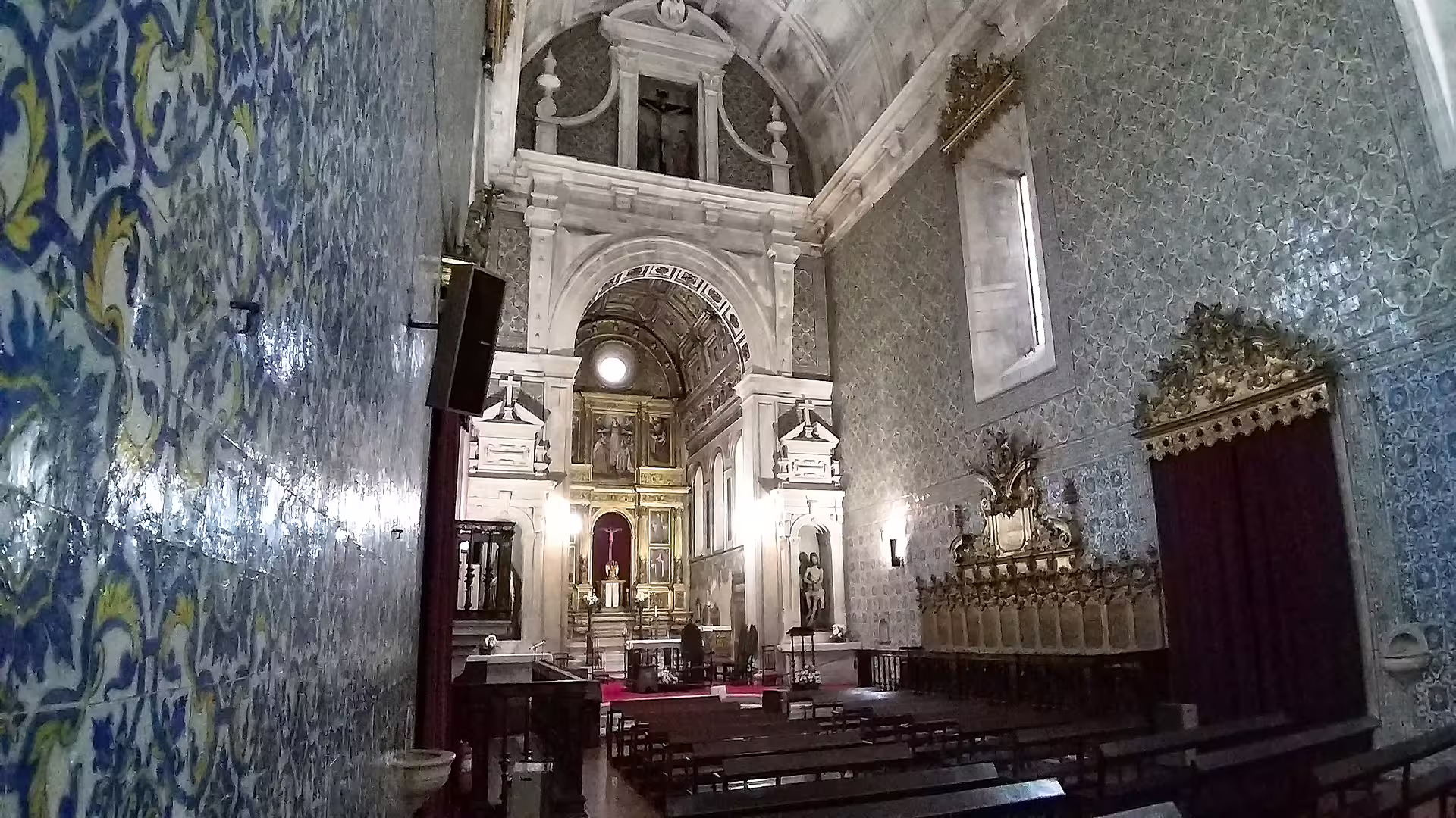 Ornate interior of a historic church with intricate tilework and altar, featured in the customizable Porto to Lisbon tour.