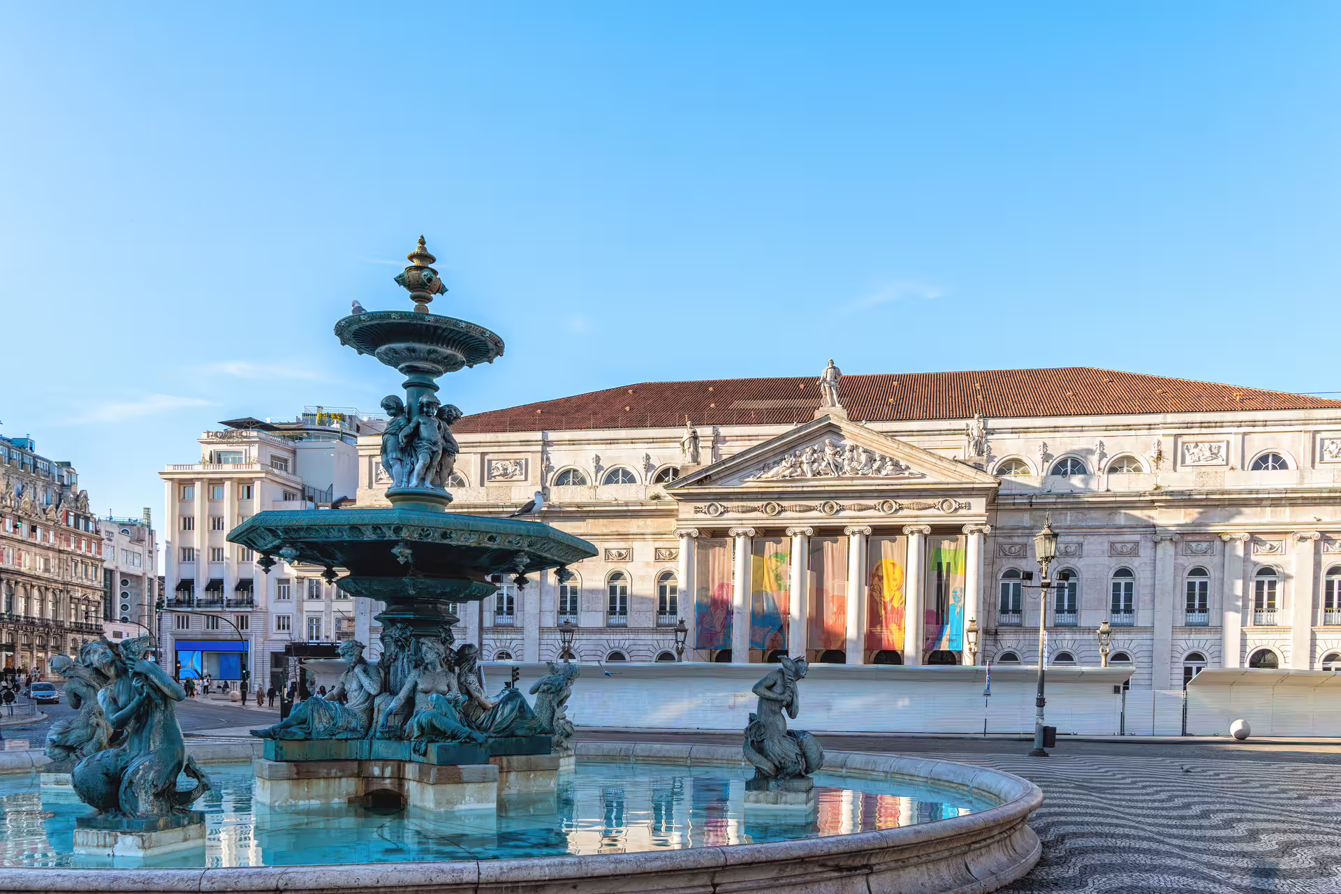 Historic Lisbon half-day tour featuring Rossio Square's iconic fountain and the grand National Theatre D. Maria II.