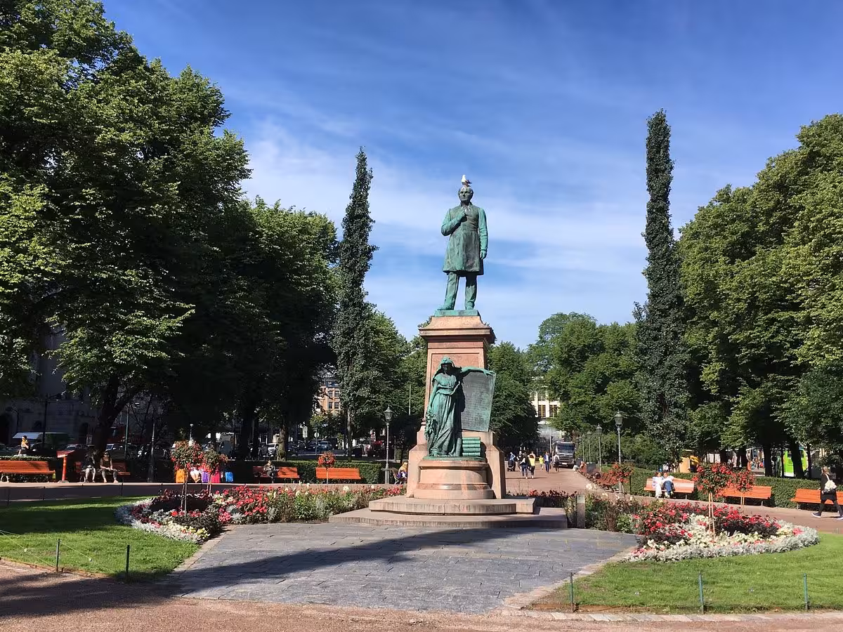 Historic statue in a lush park setting, ideal for an architecture tour exploring iconic monuments and landscapes.