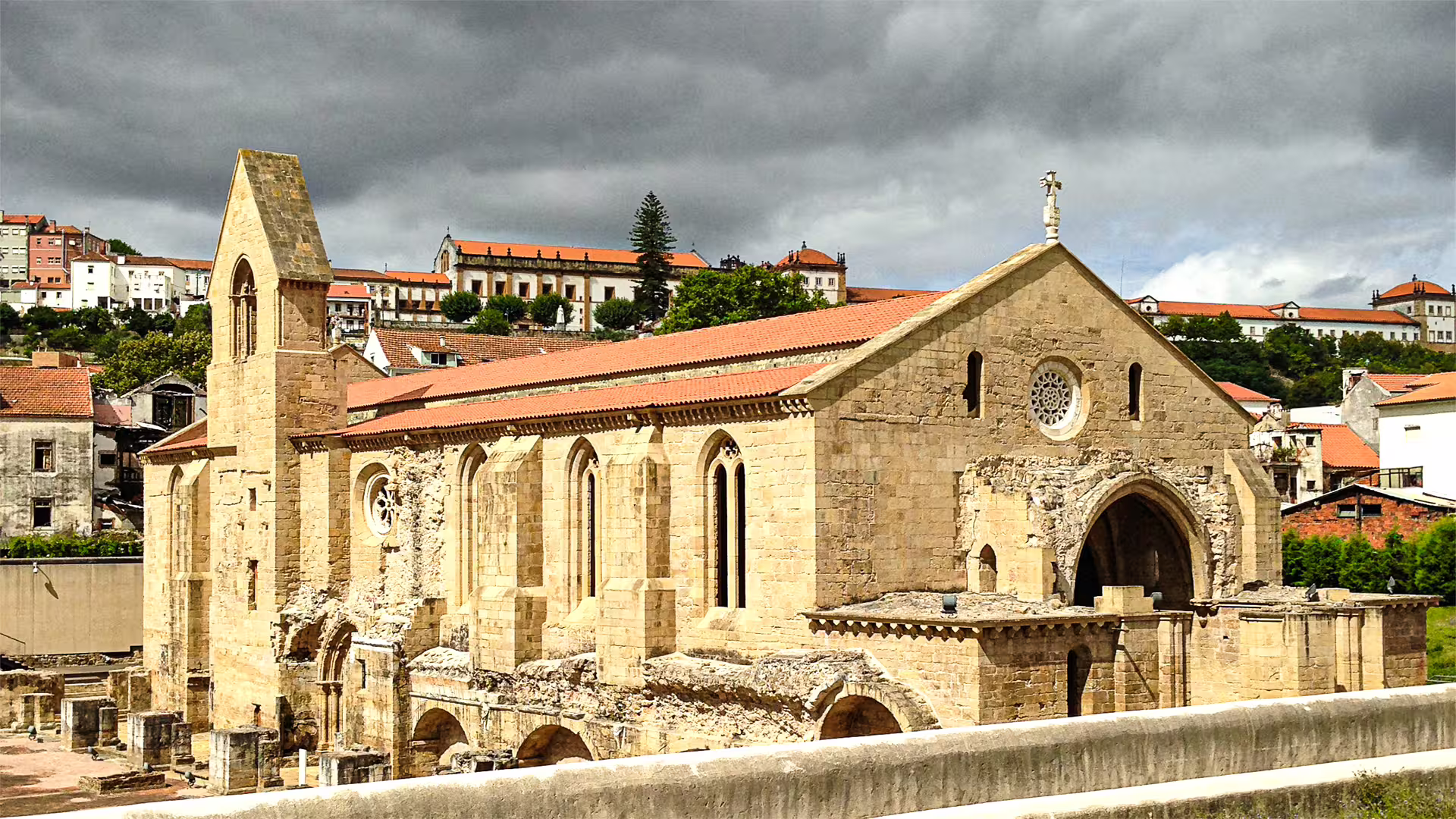 Historic stone church in Coimbra with scenic backdrop, ideal for private tours exploring ancient Roman city heritage.