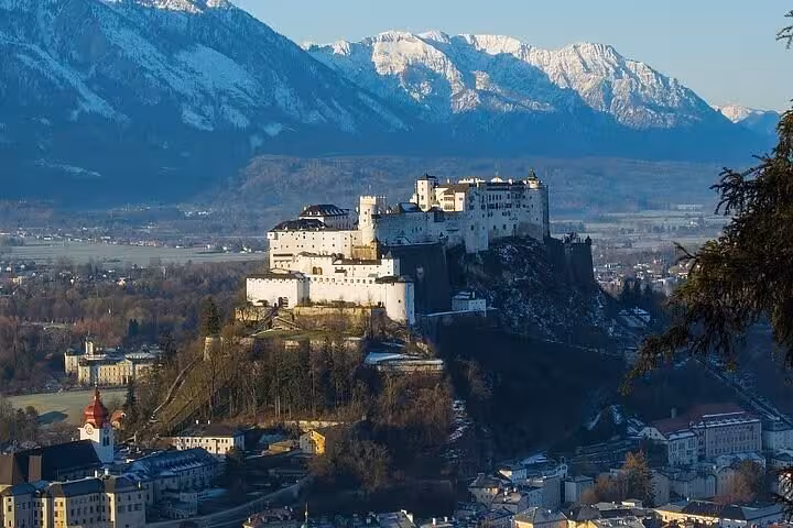 Hohensalzburg Fortress above Salzburg skyline and Alps, scenic stop on private day trip from Vienna