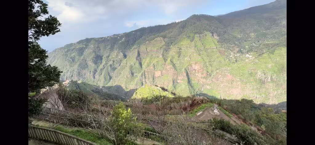 Stunning mountain vista with vibrant green valleys, a highlight of the holy wine tour's picturesque journey.