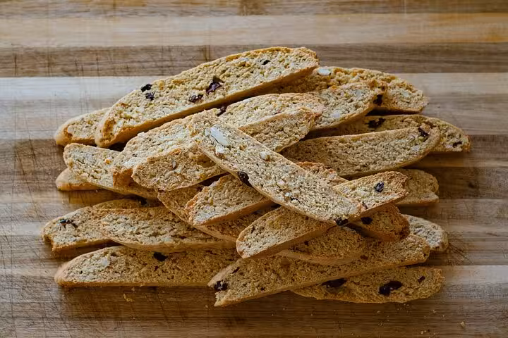 Stack of homemade biscotti on a wooden board at a biscotti making class in Florence.