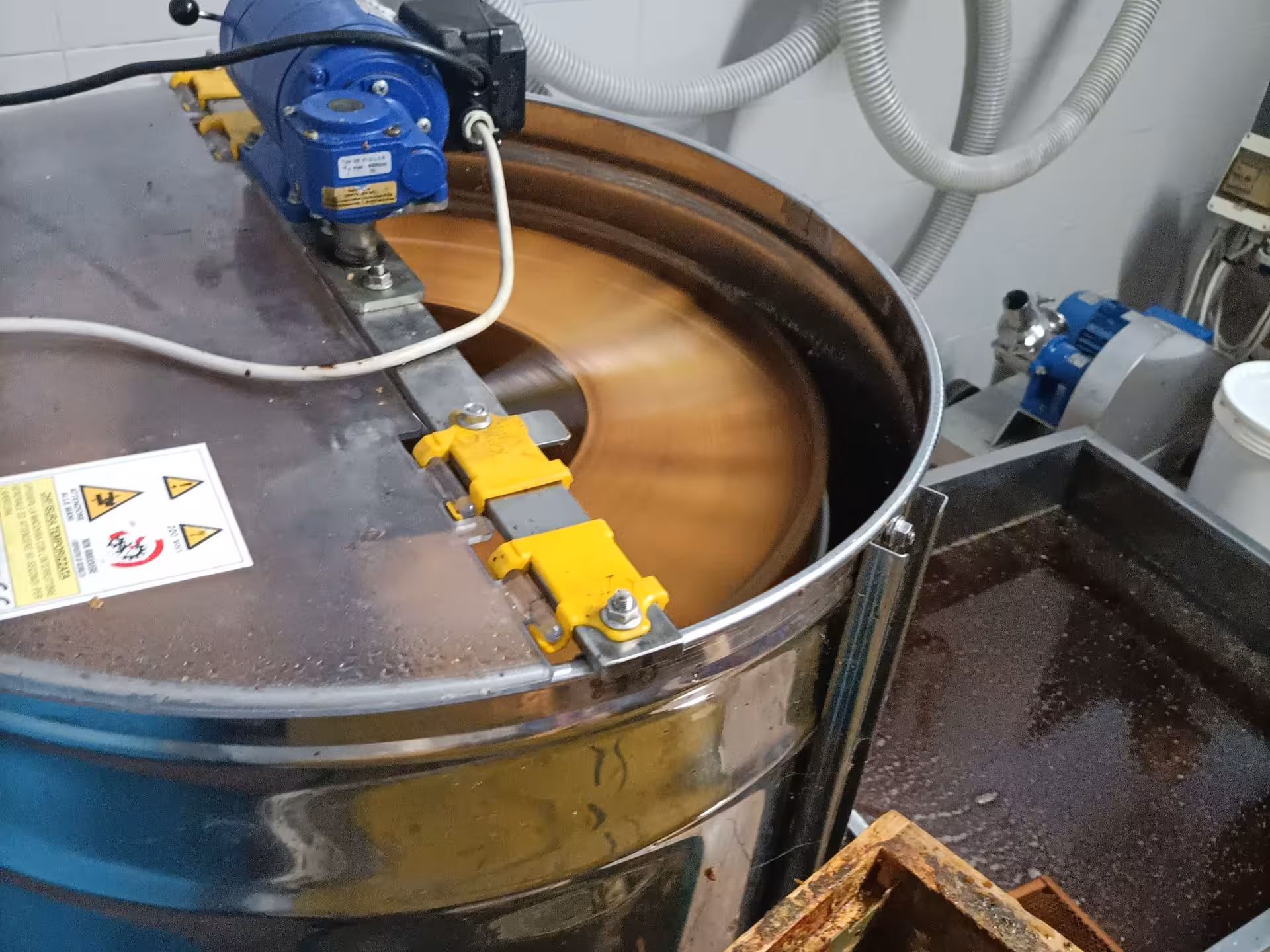 Modern honey extractor machine in action, showcasing the honey production process in Monferrato.