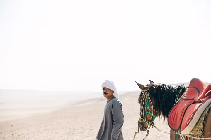 Local horse and rider in Egypt desert near Saqqara, authentic scene on Memphis and Saqqara excursion
