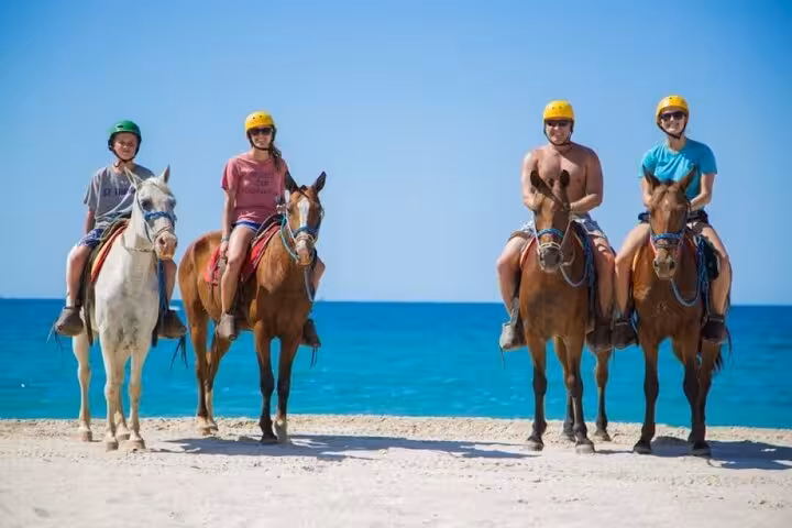 Group horse riding on a sandy Red Sea beach near Sharm El Sheikh, guided beach ride with transfers