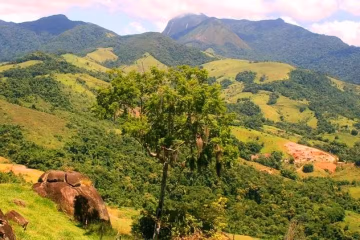 Vast panoramic view of the lush Atlantic Forest hills under a clear sky near Paraty Tours.