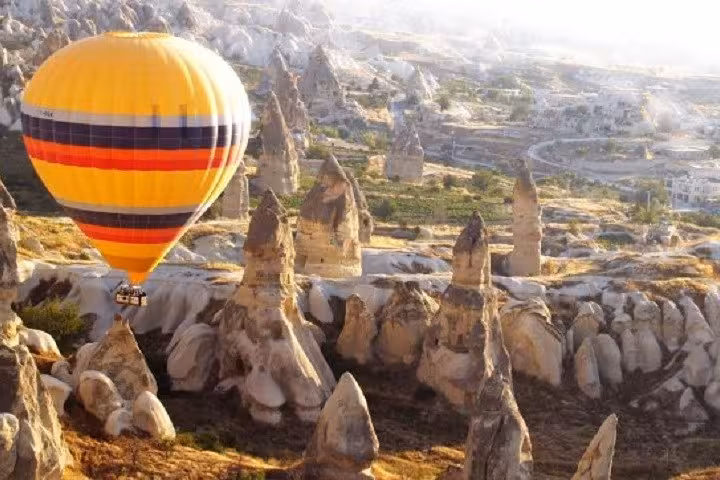 Hot air balloon over Cappadocia fairy chimneys, highlight of 2-day Istanbul to Cappadocia plane tour