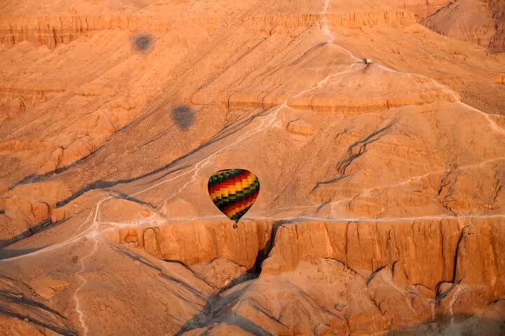Scenic hot air balloon flight above rugged desert canyon at sunrise, a lifetime experience balloon tour views