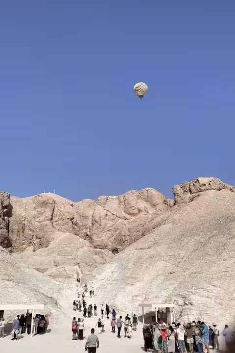 Hot air balloon over Luxor desert cliffs, a highlight of 12-day Egypt Cairo pyramids and cruise tour