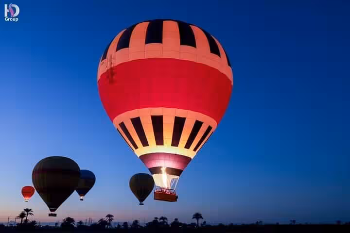Colorful hot air balloons over Luxor at dawn, VIP sunrise flight with Nile Valley views in Egypt