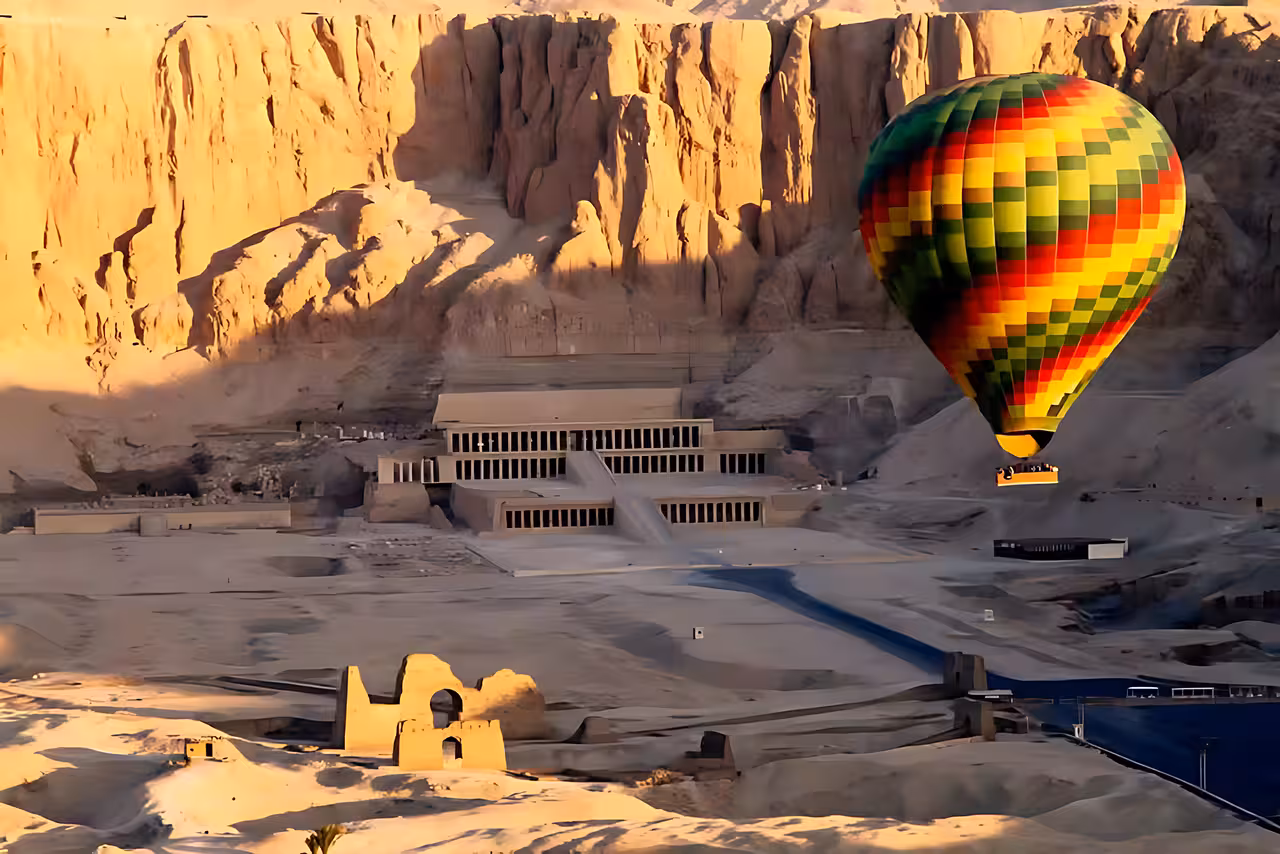 Hot air balloon over Luxor West Bank near Hatshepsut Temple on Hurghada to Valley of the Kings day trip