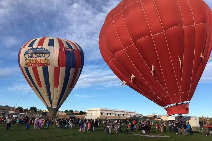 Hot air balloons inflating at dawn in Luxor, Egypt, before a scenic sunrise balloon ride over the Nile