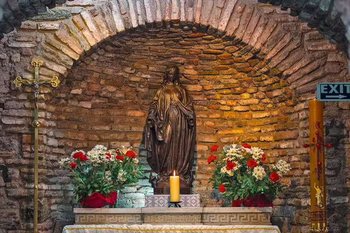 Visit the serene House of Virgin Mary shrine with floral offerings on a private Ephesus tour from Kusadasi Port.