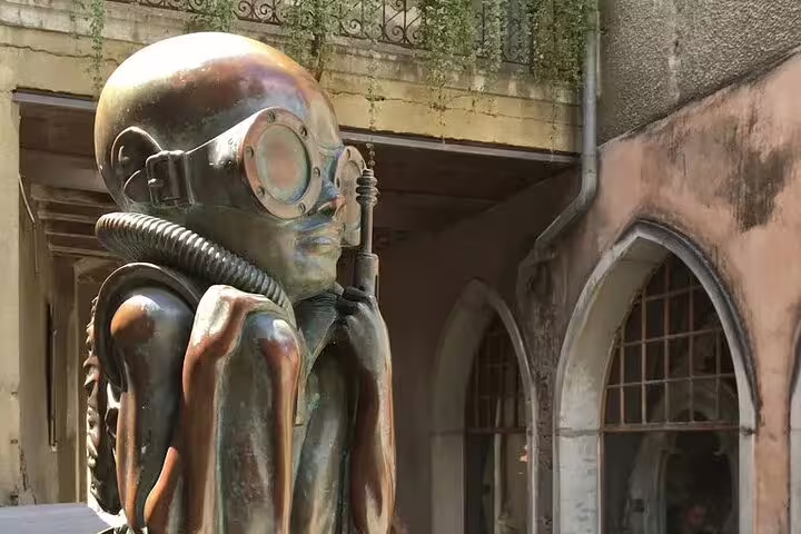 Unique sci-fi sculpture outside the H.R. Giger Museum in Gruyères, showcasing intricate futuristic design elements.