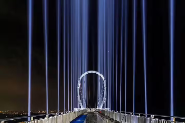 Marvel at the stunning illuminated bridge at Huangteng Canyon, a must-see attraction on your Guangzhou day tour.