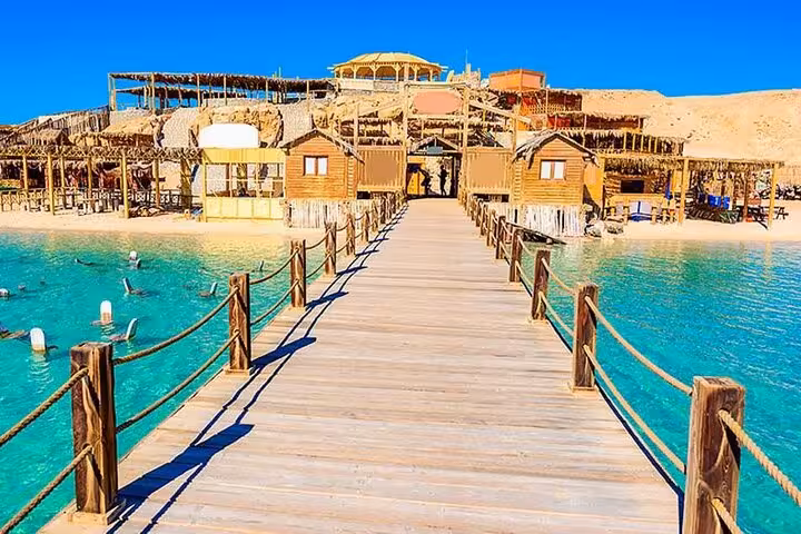Wooden pier to Hula Hula Island beach huts in Hurghada, Red Sea day trip with water sports and lunch