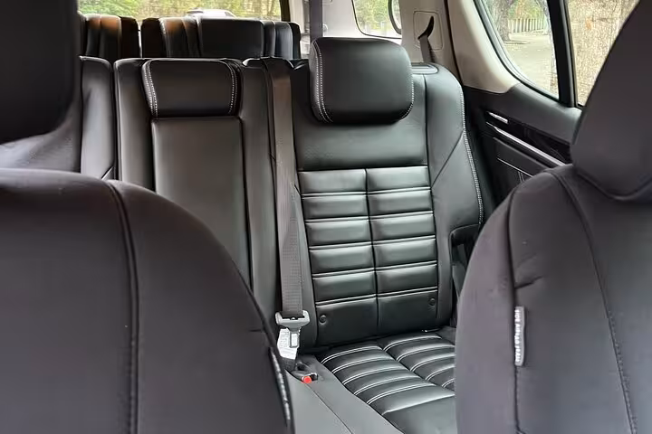 Luxurious black leather interior of a spacious vehicle used for Hunter Valley Winery group tours.