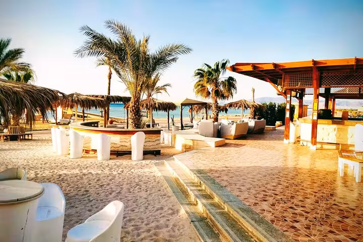 Beachfront lounge and palm-lined terrace at Hurghada hotel, perfect arrival with Hurghada Airport to hotel transfer