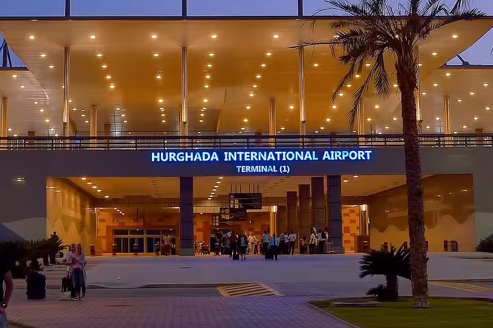 Hurghada International Airport Terminal 1 entrance at dusk, ideal for Hurghada airport to hotel transfer