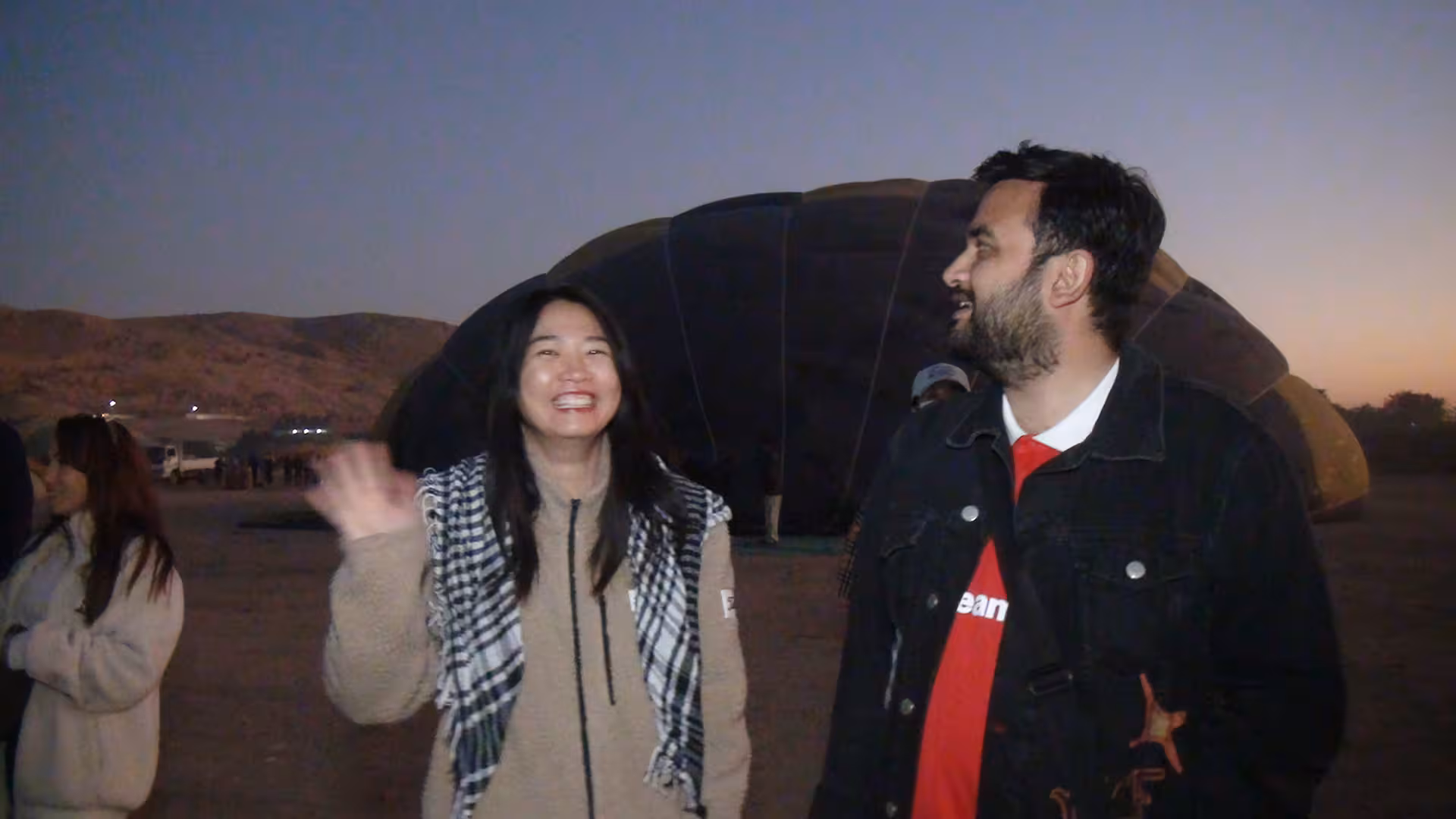 Travelers greeted by Hurghada airport transfer guide at dusk, ready for private pickup and hotel drop-off