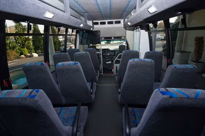Comfortable minibus interior with spacious seats for Hurghada to Aswan private transfer, air-conditioned travel