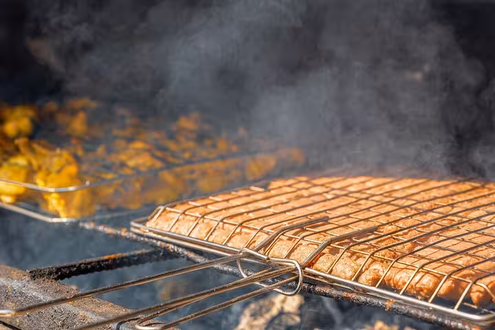 Grilled kebabs cooking for Bedouin dinner buffet on Hurghada family safari with quad ride, Jeep trip and shopping