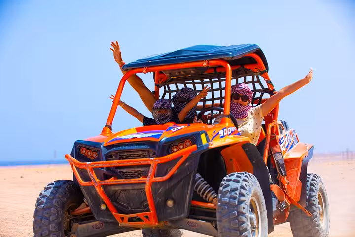 Couple enjoying Hurghada buggy safari in the desert, adrenaline off-road ride with camel, dinner and show