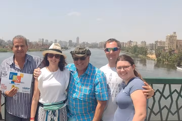 Hurghada to Cairo day trip guests with guide on Nile bridge, heading to Pyramids and Grand Egyptian Museum